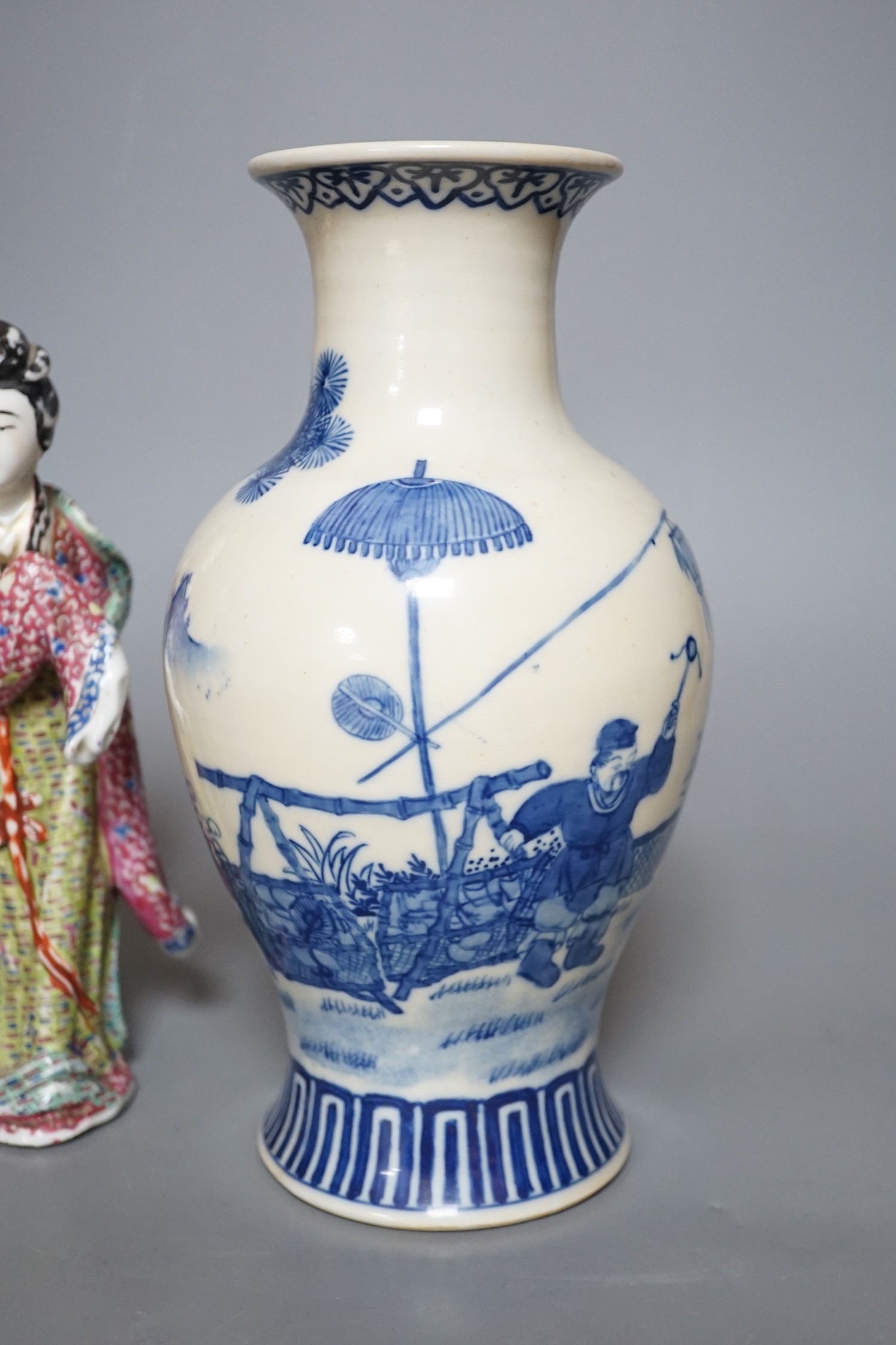 A Chinese blue and white figural vase and two polychrome figures, tallest 24cm
